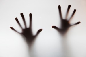 Hands touching frosted glass. Conceptual scream for help, depression, stress, panic